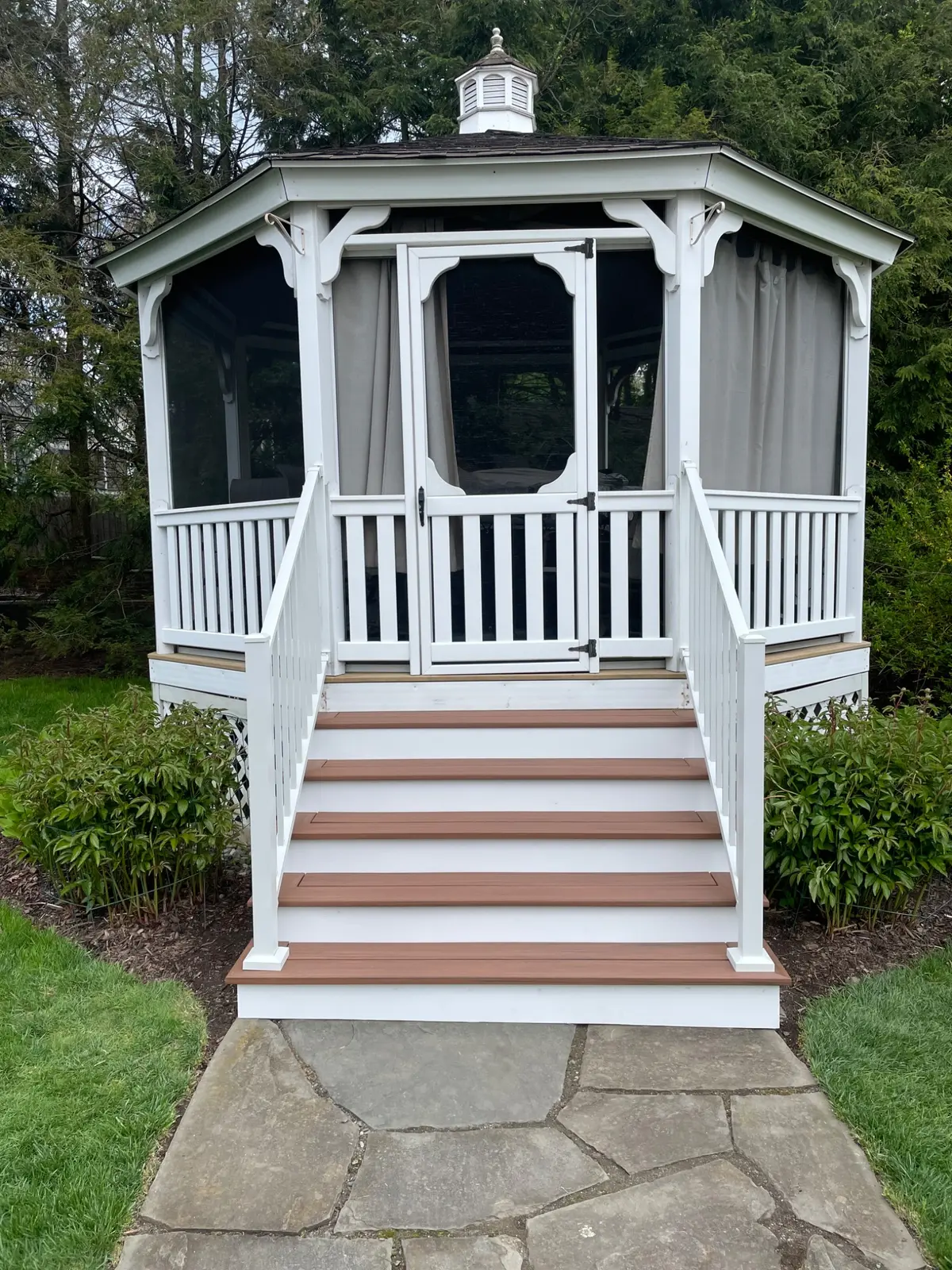 Completed gazebo stairs with composite treads and white railing
