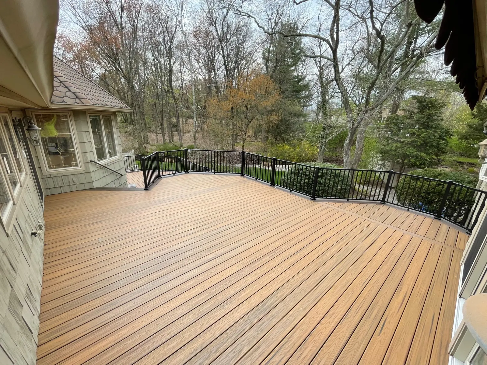 Large multi-level composite deck with black aluminum railing