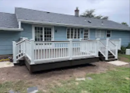 Completed rear deck with white railing and two stairways