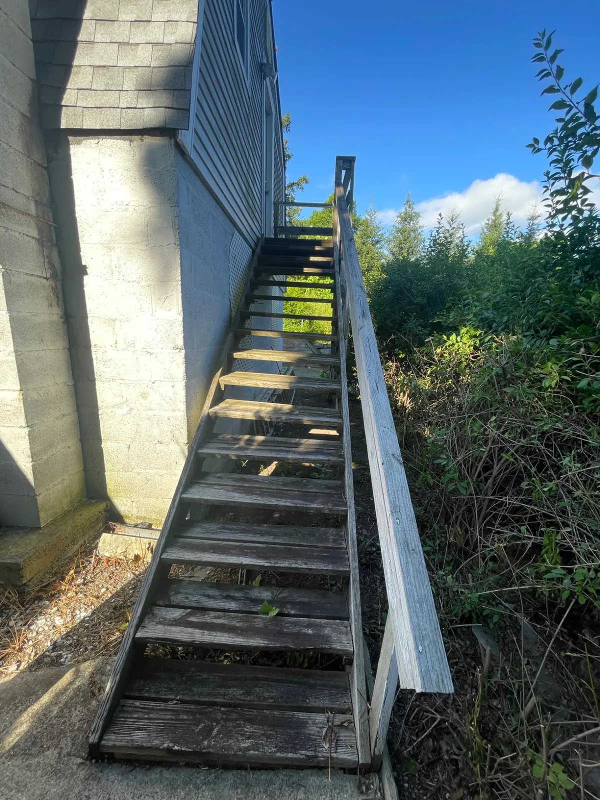 Weathered exterior wood stairway before replacement