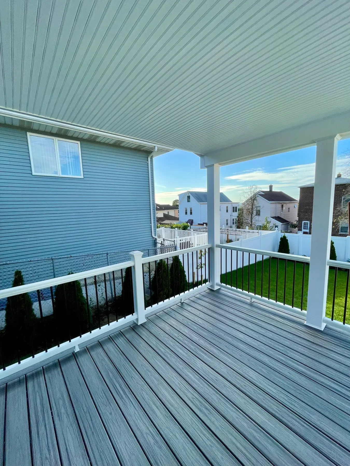 Composite decking beneath a finished roof