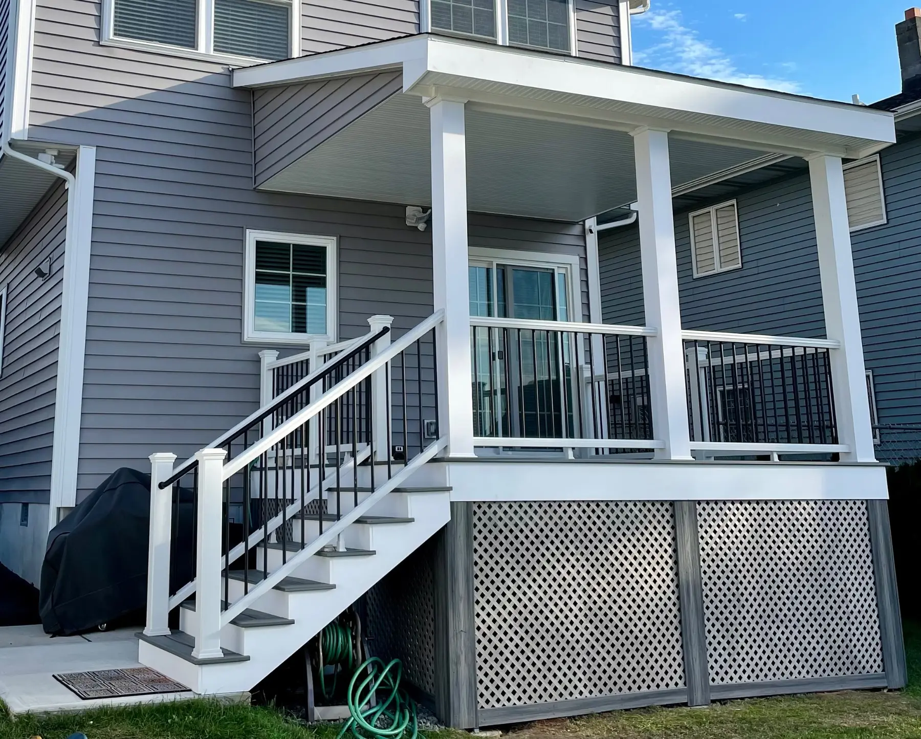 Covered composite deck with stairs and finished railing