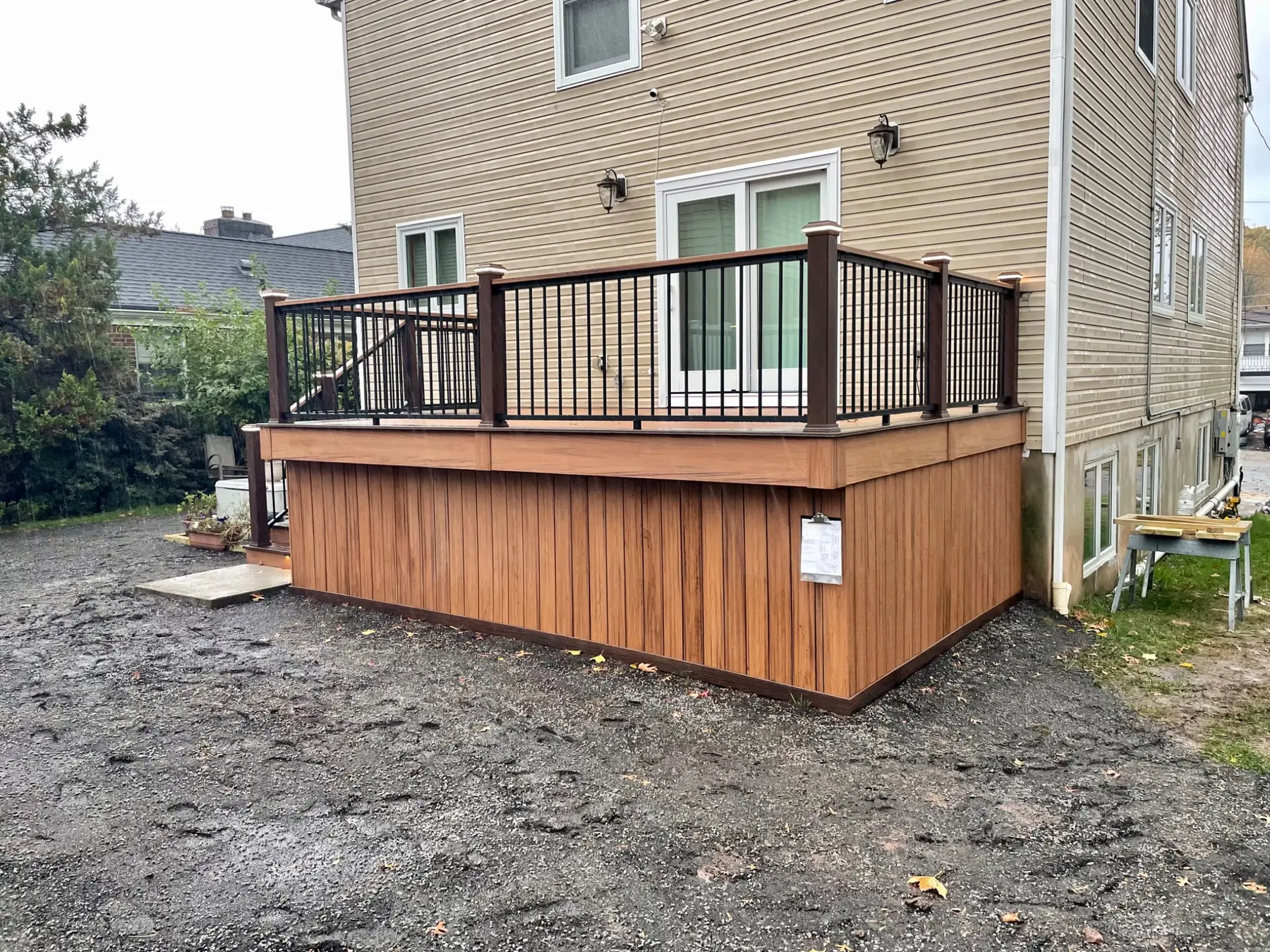 Composite deck with black aluminum railing and enclosed storage